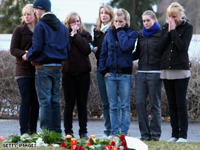 People lay flowers at the school Wednesday.