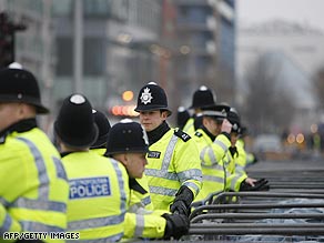 Police officers stand near barriers outside the ExCel Center in London's docklands.