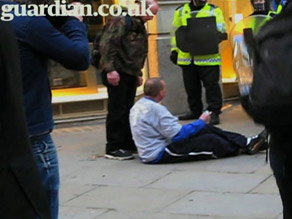 A video posted by the Guardian shows police shoving Ian Tomlinson to the ground. He later died of a heart attack.