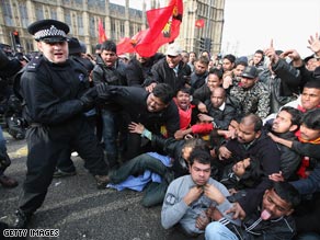 Police clash with Tamil protesters outside the Houses of Parliament.