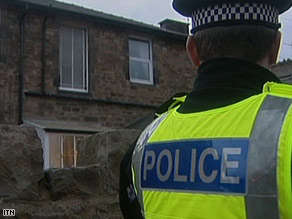 A house in Manchester, England, is searched Wednesday as part of the counterterrorism operation.