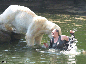 The bear attacks the woman during feeding time.