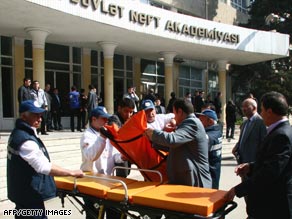 Azerbaijan police move a victim of the attack onto a stretcher.