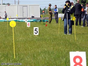 Australian soldiers and forensic experts work on the field in Fromelles, France, on Monday.