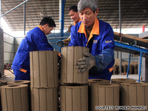 Workers at Shengzhou Stove Manufacturers prepare wood-burning stoves for firing.