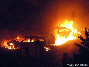 Flames engulf cars near the Viareggio railway station in western Italy on Monday.