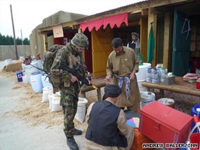 A British soldier on patrol in the mock Afghan village of Sindh Kalay.