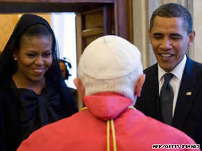 G-8 leaders wait for an aide to remove toe markers as they pose for a photo in L'Aquila, Italy.