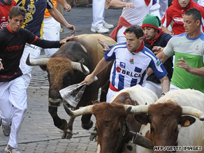 Runners take part in the running of the bulls in Pamplona, Spain on July 9.