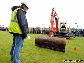 File photo shows a crane unearthing the mass grave in northern France.