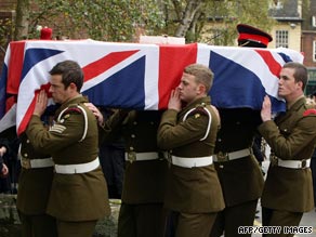 A casket containing the body of a British serviceman is carried at a ceremony in the UK.