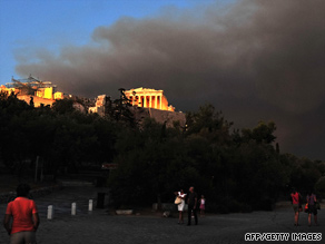 A wall of smoke forms a backdrop against the Acropolis of Athens as a blaze rages out of control.