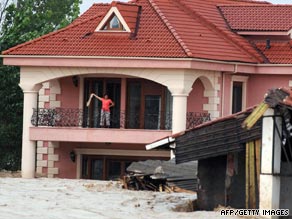 A Turkish woman awaits rescuers on her balcony following heavy morning rain in Istanbul.