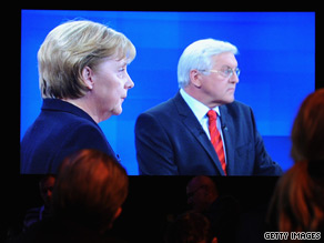 Chancellor Angela Merkel and rival Frank Walter Steinmeier are shown on a giant screen.