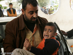 A Palestinian boy runs for cover following an Israeli airstrike Monday in Rafa, in southern Gaza.