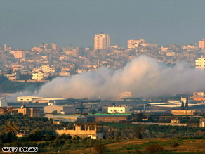 Smoke rises after an Israeli air strike on the Gaza Strip early Monday.