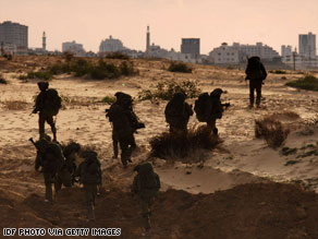 Israeli reservists prepare on the Israel-Gaza border to deploy into Gaza on Monday.