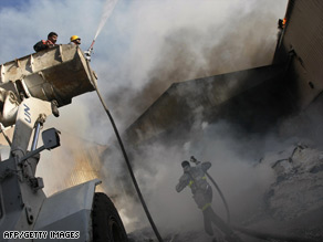 Firefighters try to douse a fire Thursday at the United Nations' main relief agency in  Gaza City.