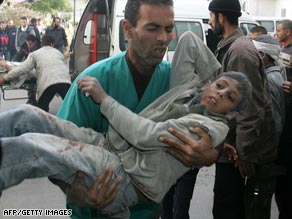 Palestinians carry a boy wounded in an Israeli military strike to hospital on January 14.