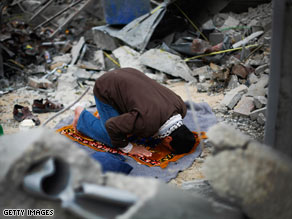 A Palestinian man Monday prays in the rubble of his home,  destroyed during Israel's offensive in Gaza.