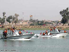 An Iraqi security patrols a water way in Basra.