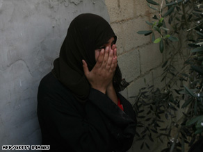 A relative of Palestinian killed by Israeli helicopter fire Tuesday mourns at his funeral the same day.