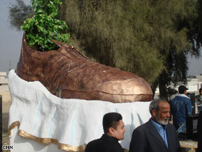 A monument to a shoe thrown at former President Bush is unveiled at the Tikrit Orphanage complex.