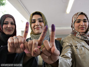 Iraqi women show off their ink-stained fingers after voting Saturday in Baghdad.