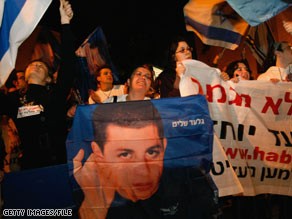 A portrait of Gilad Shalit is held during a protest demanding his release in Tel Aviv, Israel, in January.