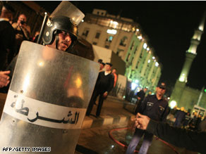 Egyptian police secure the site of a blast that killed a French tourist near a mosque and coffee shops Sunday.