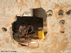 Palestinian children make coffee behind a bullet and rocket riddled wall in Rafah, Gaza, on January 24, 2009.