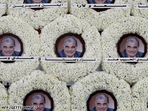 White wreaths with photos of Rafik Hariri at his tomb.