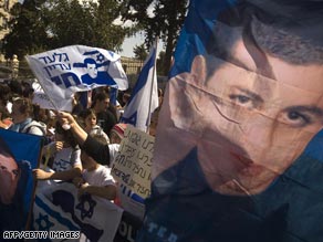 Israelis demonstrate at the prime minister's home holding flags of Gilad Shalit.