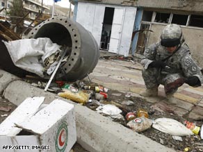 A U.S. soldier looks over debris after a suicide bombing Thursday in central Baghdad.