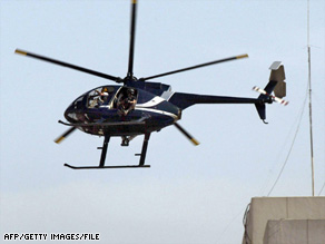 A helicopter for the private security firm then known as Blackwater flies over Baghdad in October 2003.