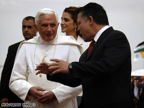 Jordan's King Abdullah II speaks with Pope Benedict XVI at the international airport in Amman on Friday.