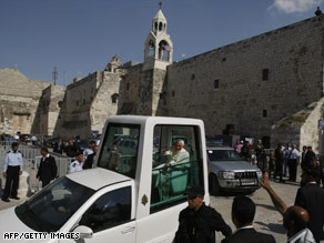 Pope Benedict leaves the Church of Nativity in his pope mobile after celebrating Mass Wednesday in Bethlehem.
