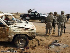 U.S. soldiers examine the scene of a bombing Thursday in Kirkuk, Iraq, that killed eight Sons of Iraq members.