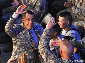 Stephen Colbert high-fives a serviceman after submitting to a military-style haircut in Iraq on Sunday.