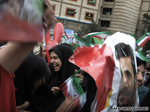Supporters of President Ahmadinejad wave flags at a massive rally in Tehran Sunday to celebrate his victory.