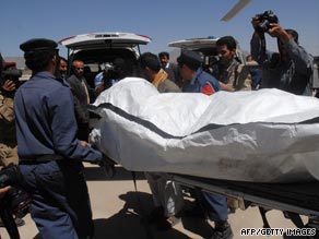 Yemeni military and medical staff carry the body of one of three killed hostages found in northern Yemen.