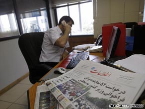 A foreign journalist speaks on the phone Wednesday in Tehran.