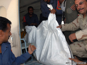 Yemeni military and medical staff remove the body of one of the hostages.