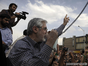 Mir Hossein Moussavi addresses supporters Monday in Tehran, Iran. He's called for a massive march Thursday.