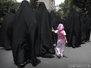A young girl accompanies Iranian women as they walk to hear the ayatollah give his speech Friday.