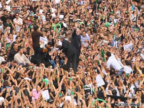 Mir Hossein Moussavi, center, is surrounded by supporters in Tehran, Iran, on Thursday.