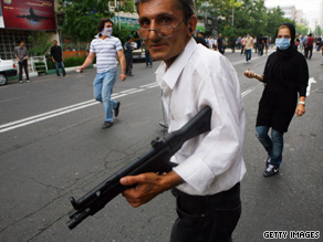 A supporter of Mir Hossein Mousavi carries a toy gun to scare away forces in Tehran on Saturday.