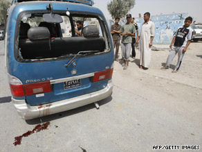A roadside bomb hits a minibus Monday in Baghdad's Sadr City, leaving a bloody scene with three dead.