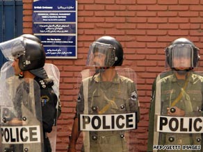 Iranian police stand guard Tuesday outside the British Embassy in Tehran during a protest.