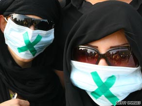 A woman is seen throwing a rock at one recent protest in Tehran.